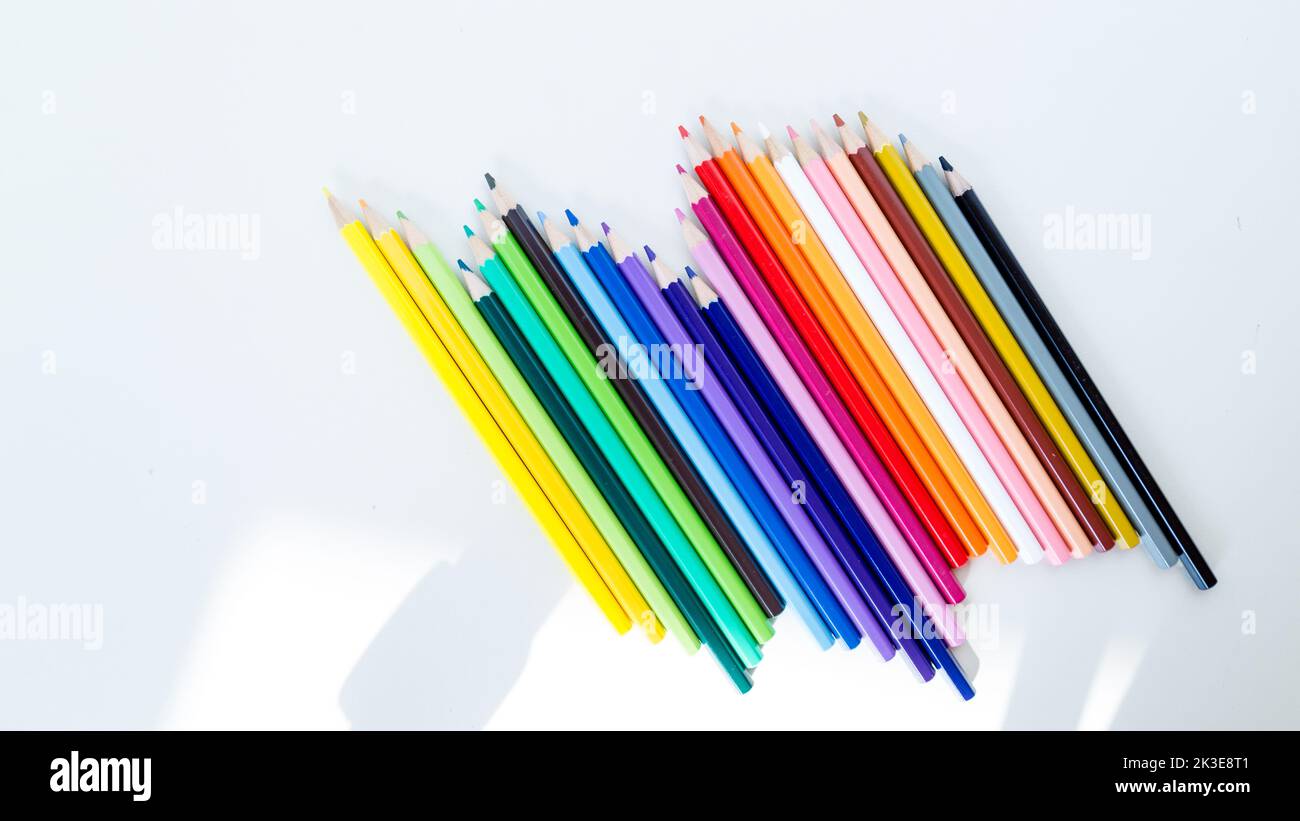 Colored pencil crayons in a row on white background Stock Photo - Alamy