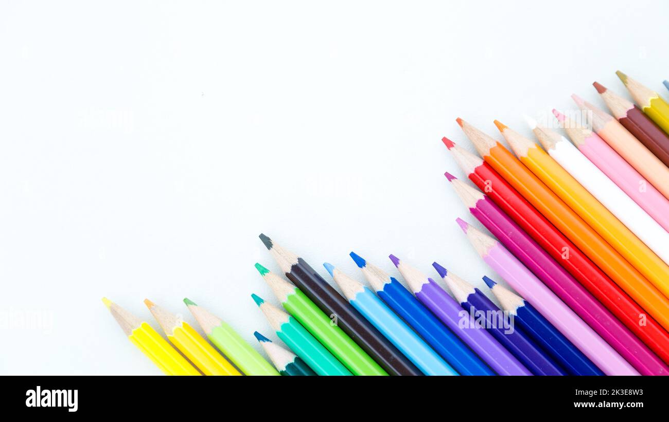 Colored pencil crayons in a row on white background Stock Photo - Alamy