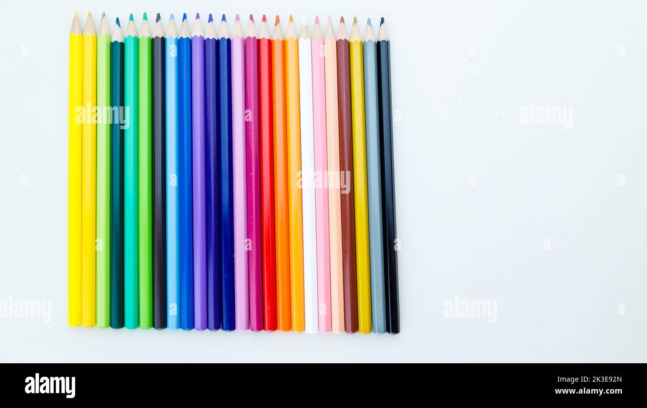 Colored pencil crayons in a row on white background Stock Photo - Alamy
