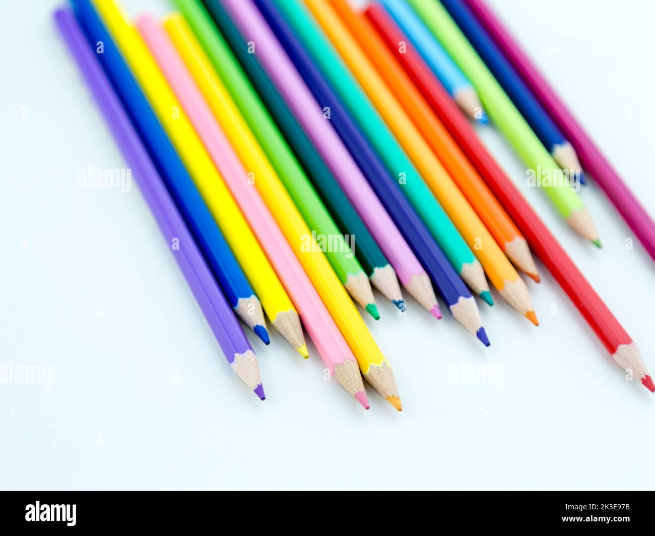 Colored pencil crayons in a row on white background Stock Photo - Alamy