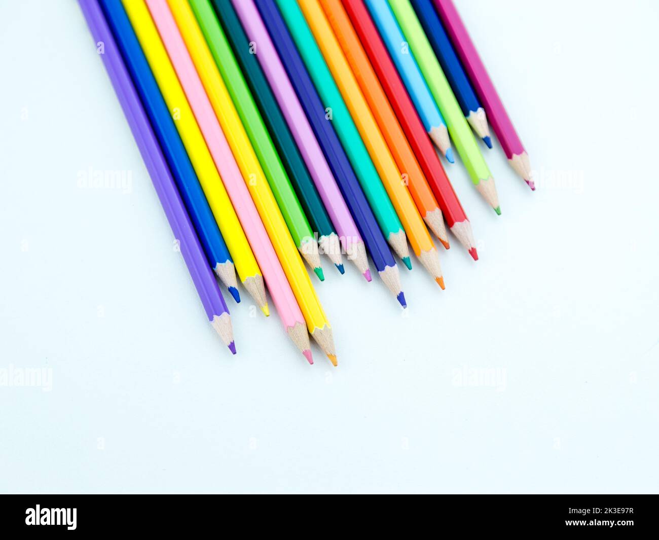 Colored pencil crayons in a row on white background Stock Photo Alamy