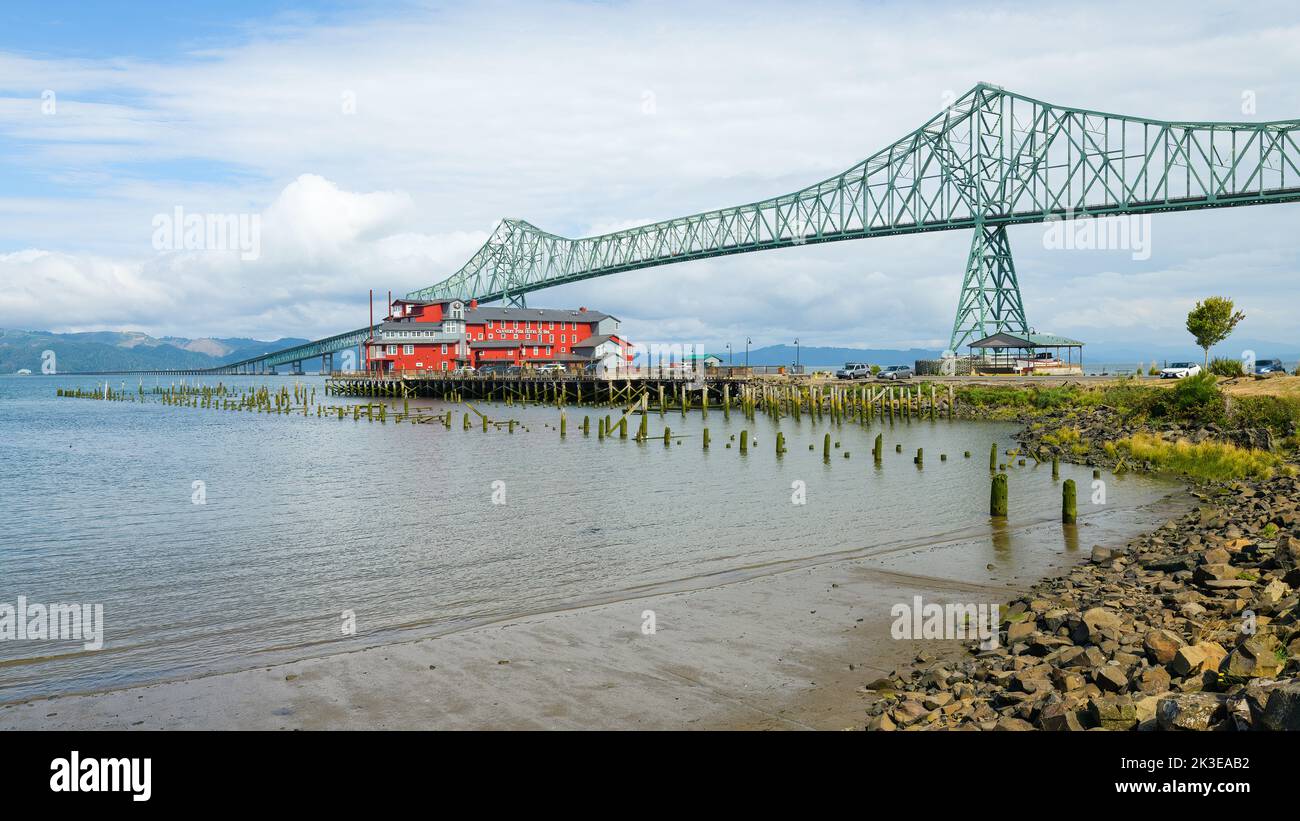 Astoria, OR, USA - September 14, 2022; Astoria Megler Bridge across the Columbia river between Oregon and Washington and over the red boutique Cannery Stock Photo
