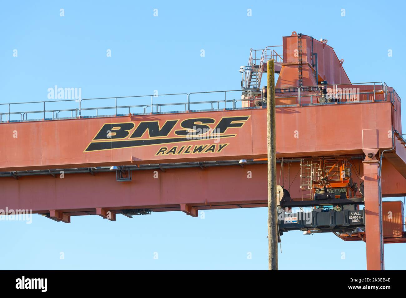 Seattle - September 07, 2022; BNSF name and logo on heavy lift goods crane with blue sky Stock Photo