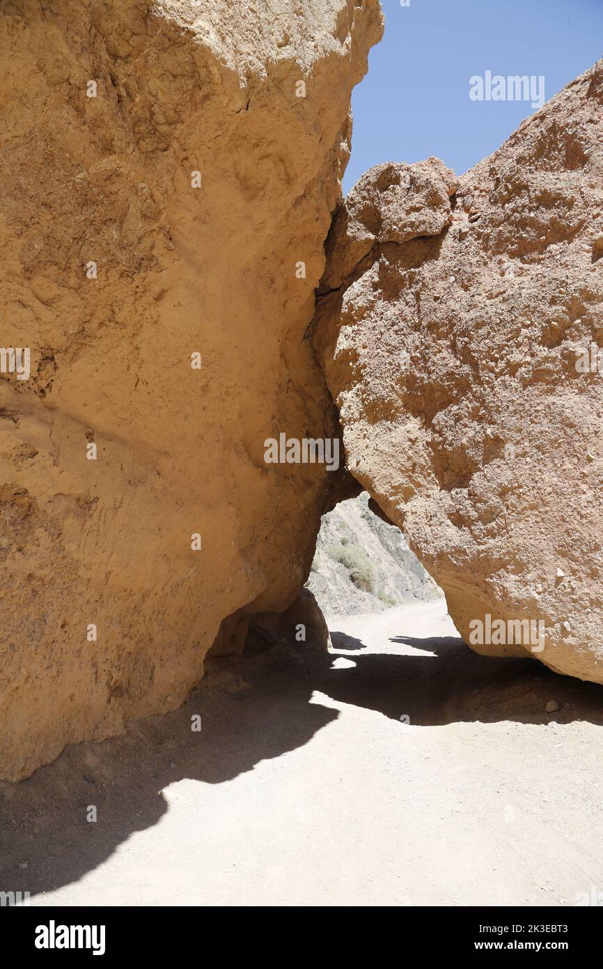 Two touching huge rocks, leaving a small opening in Charyn Canyon National Park, Kazakhstan Stock Photo