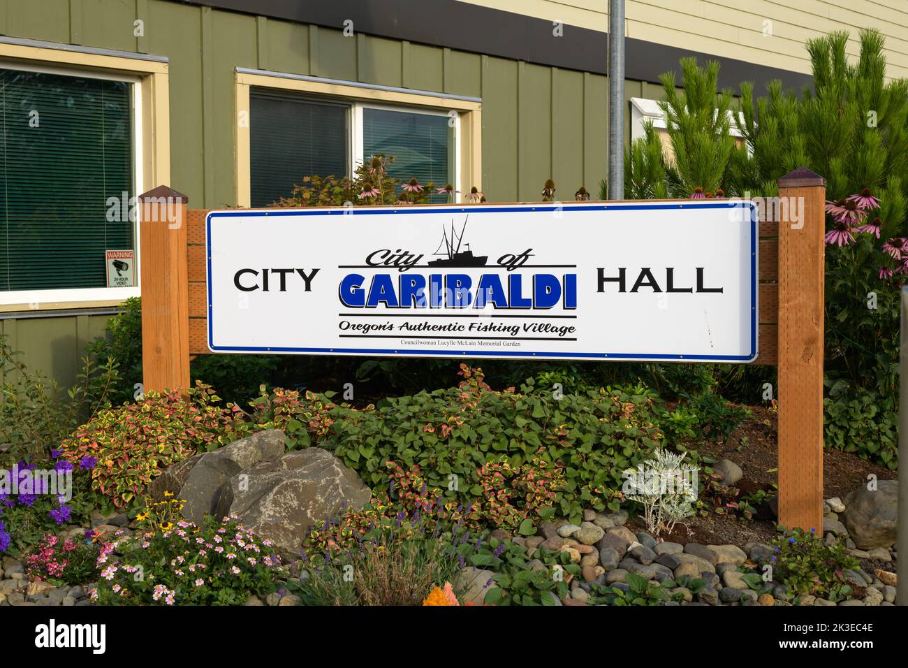 Garibaldi, WA, USA - September 21, 2022; Sign for city hall in Garibaldi on the Oregon Coast among flowerbed and with wooden posts Stock Photo
