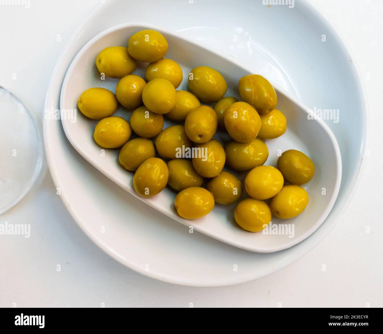 Bunch of olives served on plate. Appetizer on table Stock Photo