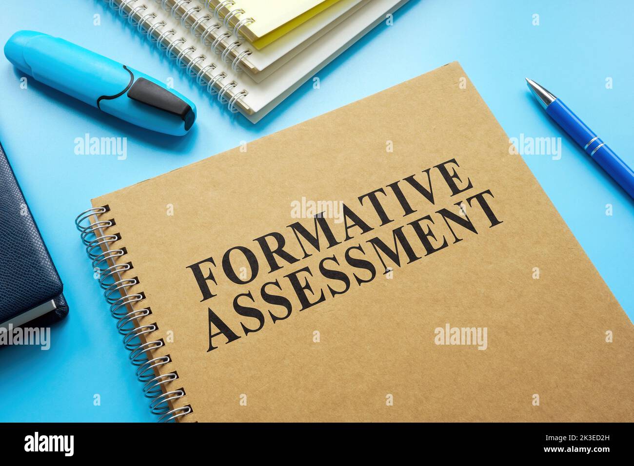 Formative Assessment guide and notebooks on the desk. Stock Photo