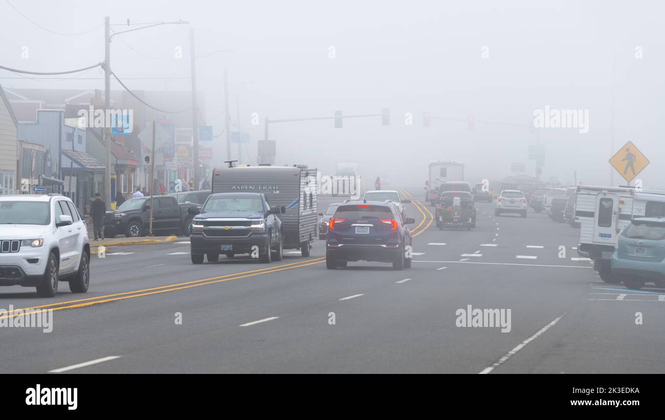 Depoe Bay, OR, USA - September 15, 2022; Foggy morning as the ocean fog obsures Highway 101 as it passes through downtown Depoe Bay Oregon Stock Photo