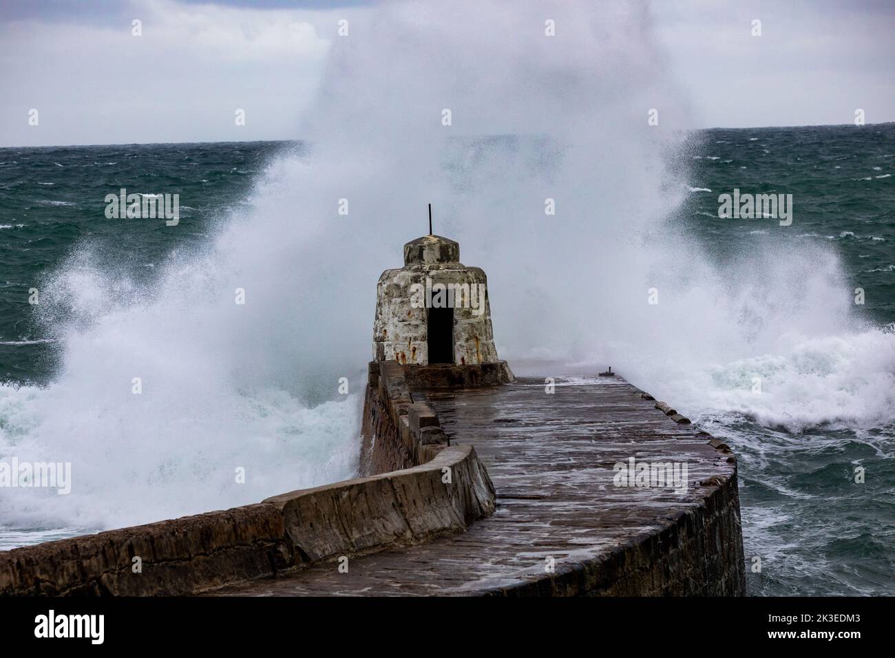 Portreath,Cornwall,26th September 2022,Strong North westerly winds today brought large waves to Portreath in Cornwall. Surfers enjoyed riding the high waves which also crashed over the Monkey Hut and sea wall. The weather forecast is for 15C and strong winds for the rest of the day.Credit: Keith Larby/Alamy Live News Stock Photo