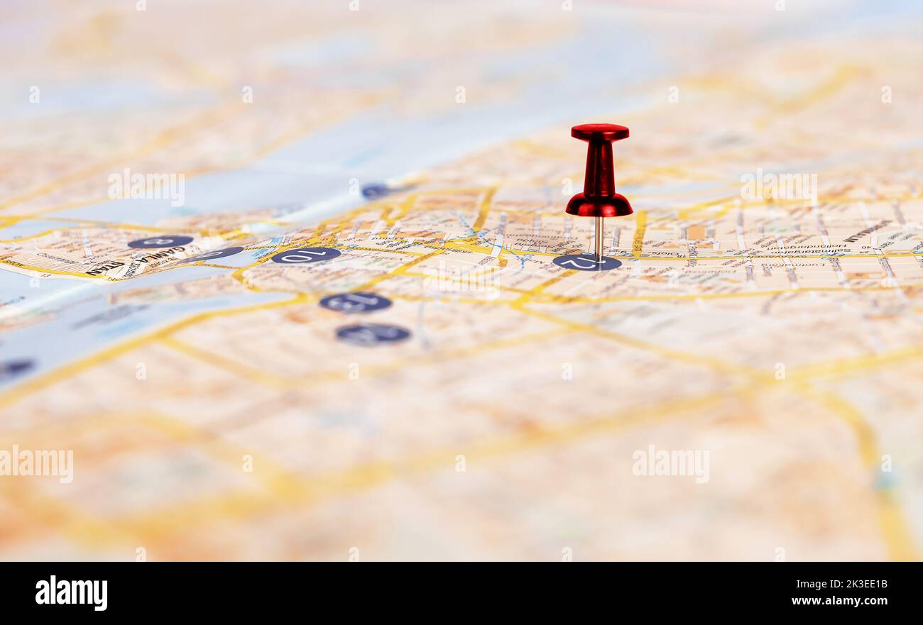 Pin closeup on paper map. Trip route planning concept. photo Stock Photo