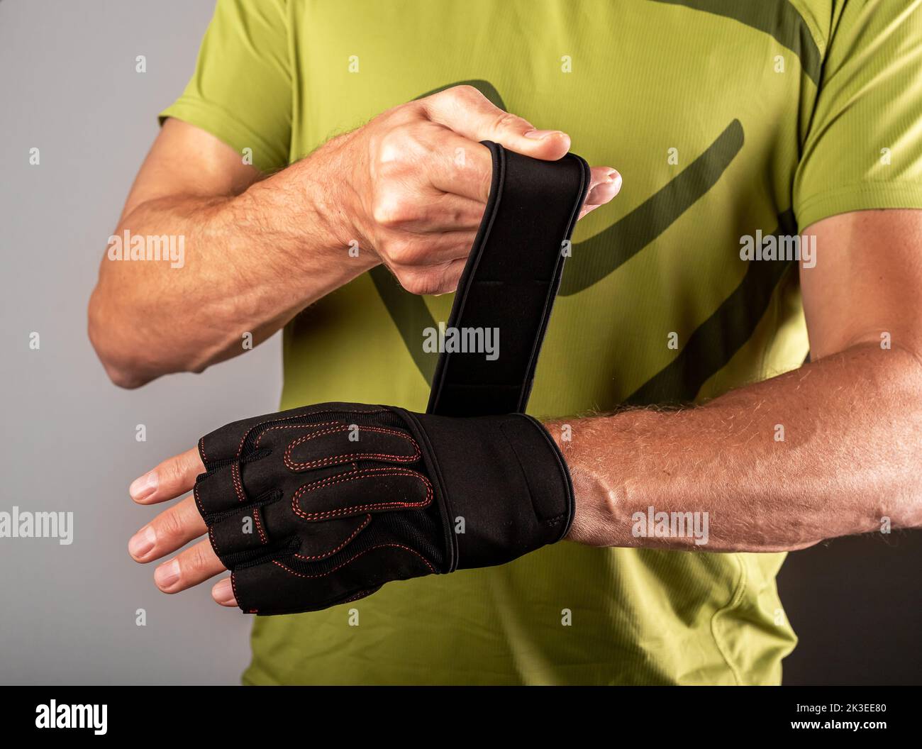 Wrapping, putting on training workout gloves on hands for wrist protection. photo Stock Photo