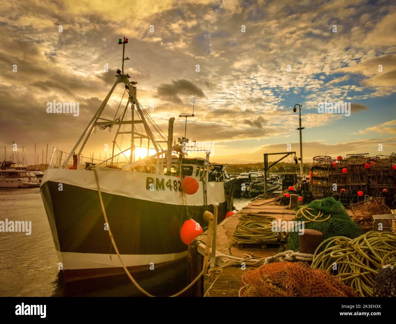 Torbay, UK. 26th Sep, 2022. Sunset over a fishing trawler in Torquay Harbour Credit: Thomas Faull/Alamy Live News Stock Photo