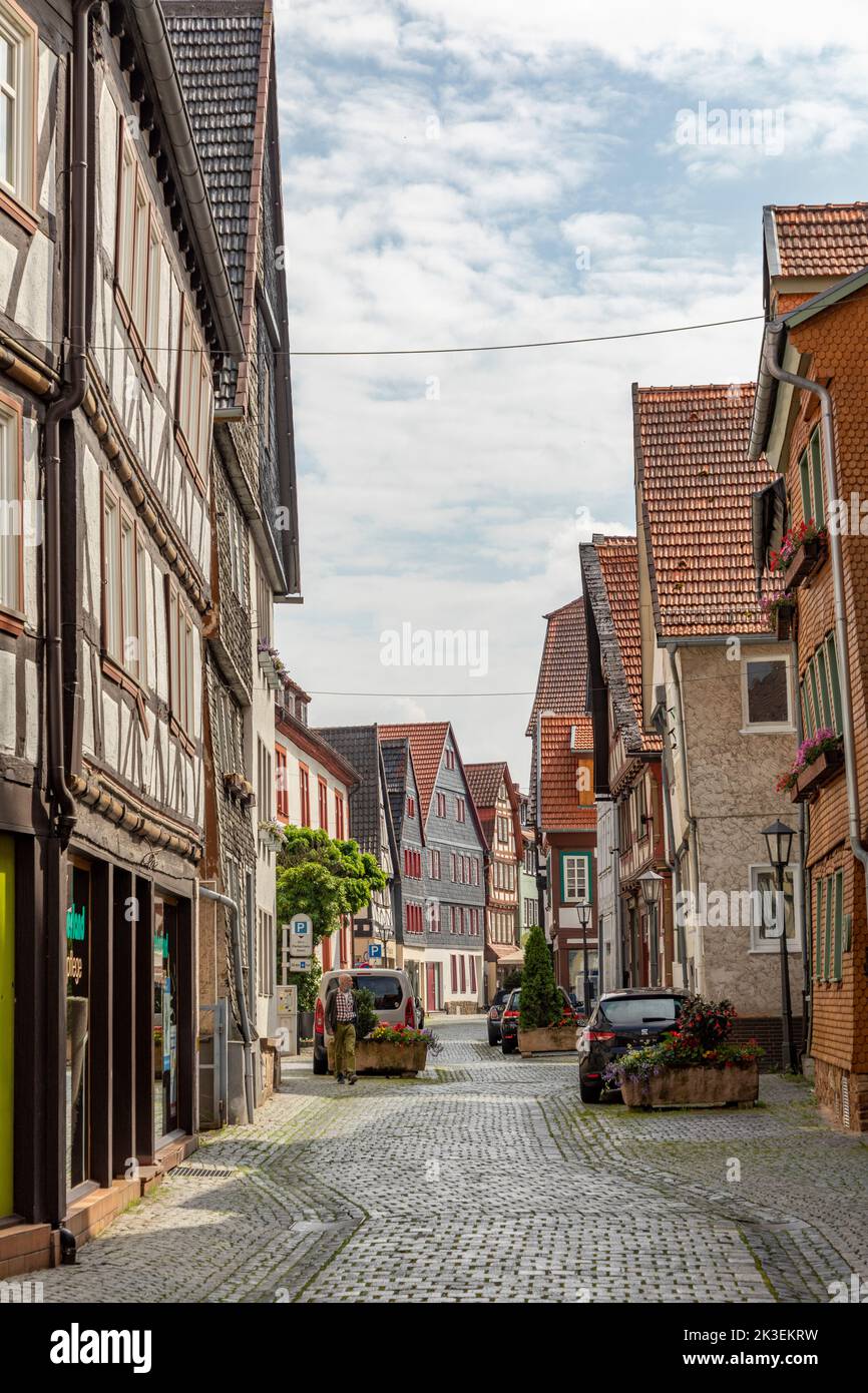 Alsfeld, Germany - June 25, 2021: small historic road covered with cobble stones and half timbered historic houses in Alsfeld, Germany. Stock Photo