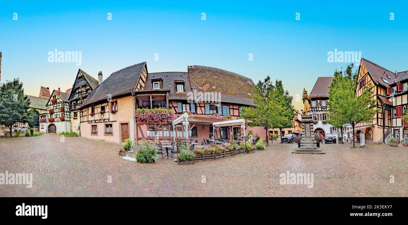 Eguisheim, France - October 4, 2021: scenic small road with half timbered houses in the historic village of Eguisheim in the Alsace region in France. Stock Photo