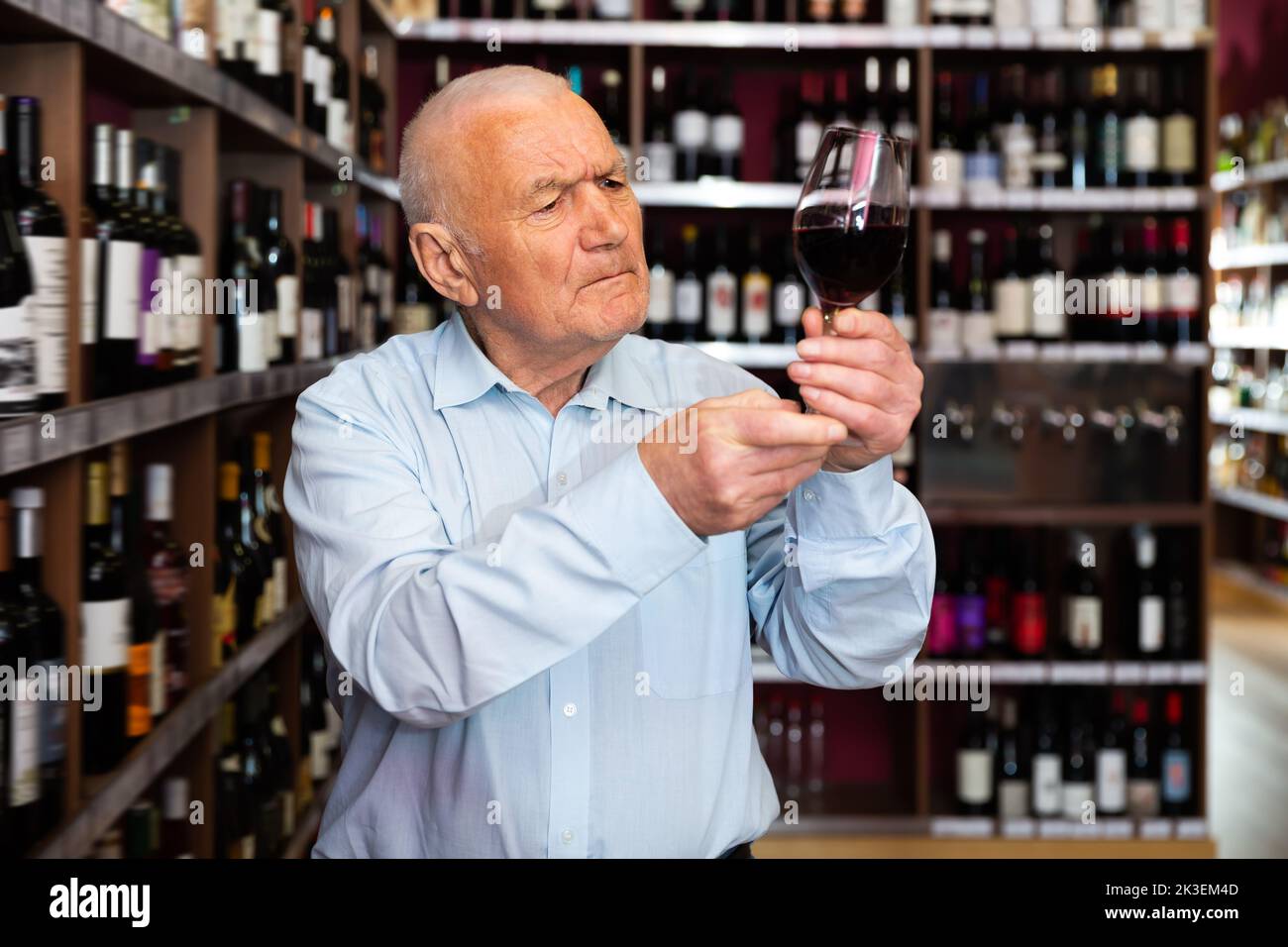 Portrait of positive man tasting red wine Stock Photo - Alamy