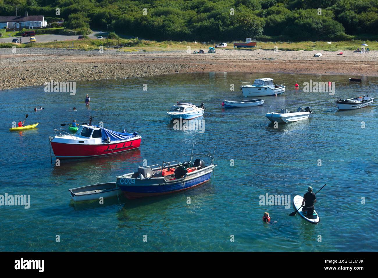 Charming Trefor village Wales.  Secluded beach on a pretty bay. Small boats on the water with a quiet beach in the background. Stock Photo