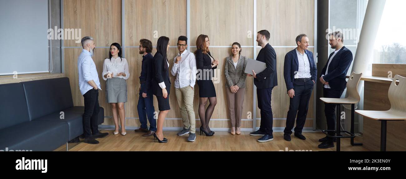 Diverse group of people communicating after business conference or corporate meeting Stock Photo
