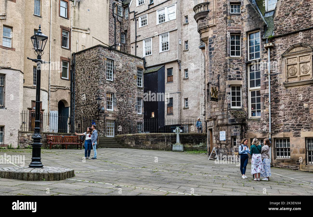Tourists taking a selfie in a courtyard off the Royal Mile outside Writer's Museum, Makar's Court, Edinburgh, Scotland, UK Stock Photo