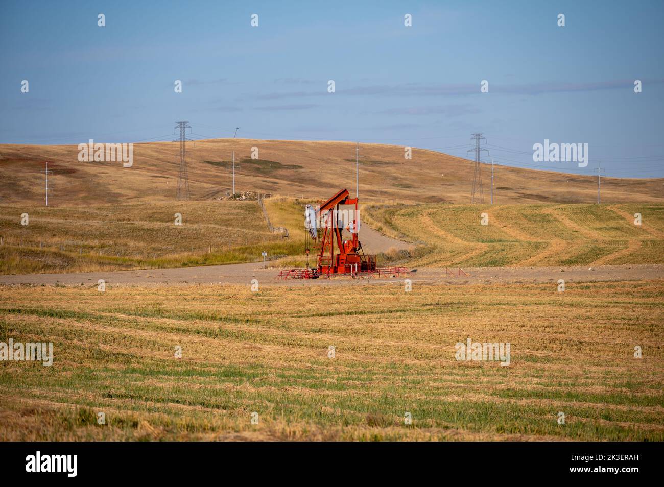 Oil well in rural Alberta Canada pumping oil and gas. Stock Photo