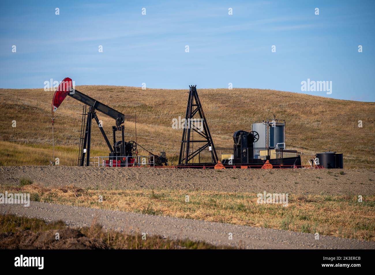 Oil well in rural Alberta Canada pumping oil and gas. Stock Photo