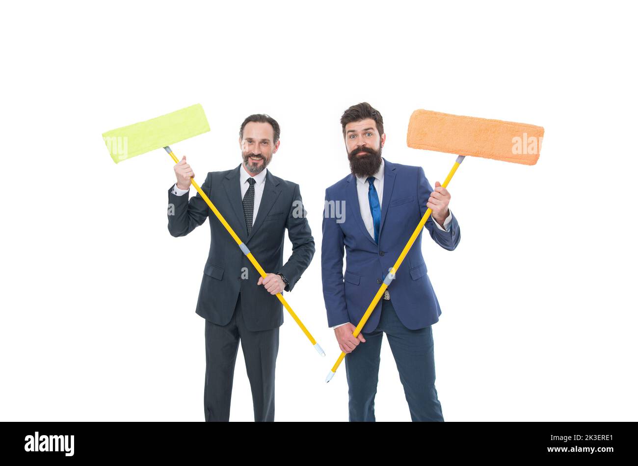 mature bearded men in formal suit hold householding mop. clean slate. Partnership and teamwork. businessmen clear wall to white. cleaning company Stock Photo