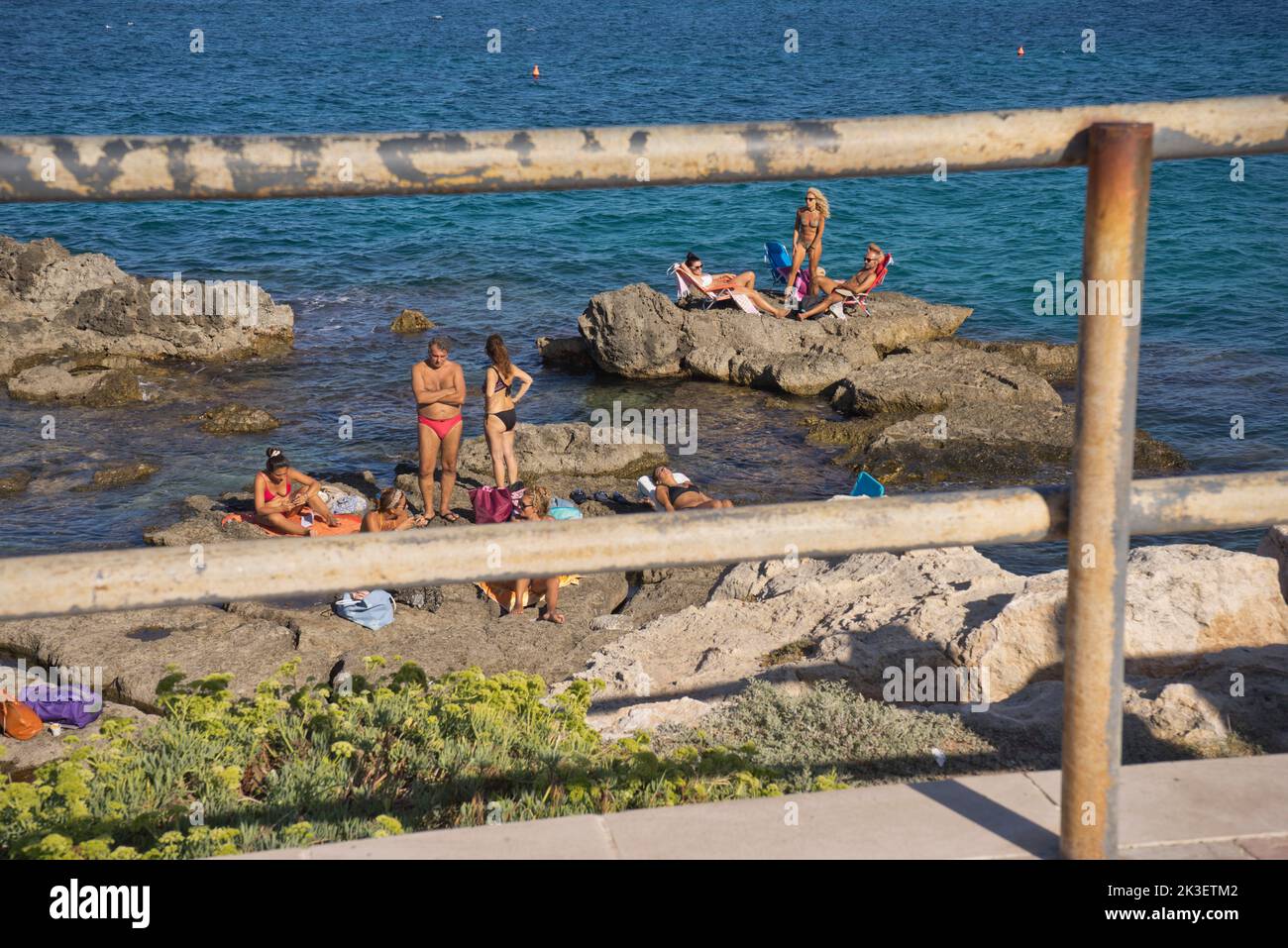 Local people and tourists at a beach by the old town of Monopoli, Puglia,Italy Stock Photo