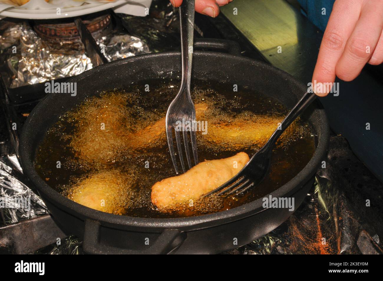 Cooking some meat empanadas in olive oil Stock Photo Alamy