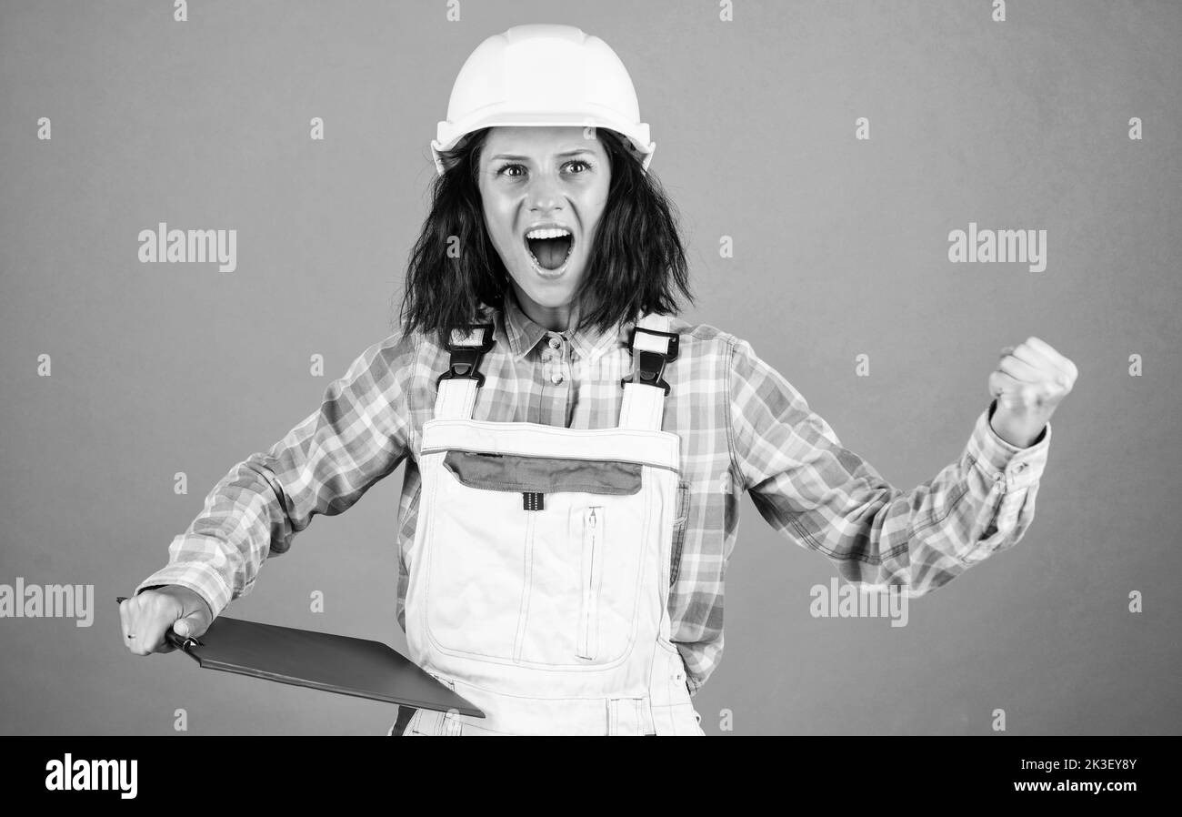 smiling female architect in safety hard hat, blueprint Stock Photo - Alamy