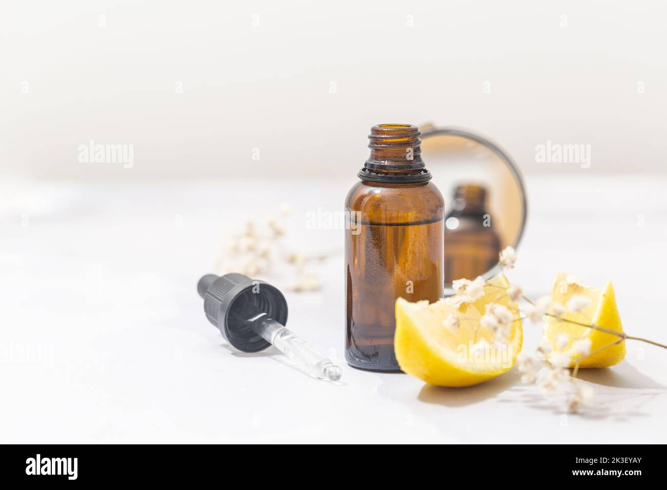 Flat lay composition with bottle of natural essential oil on white marble Stock Photo