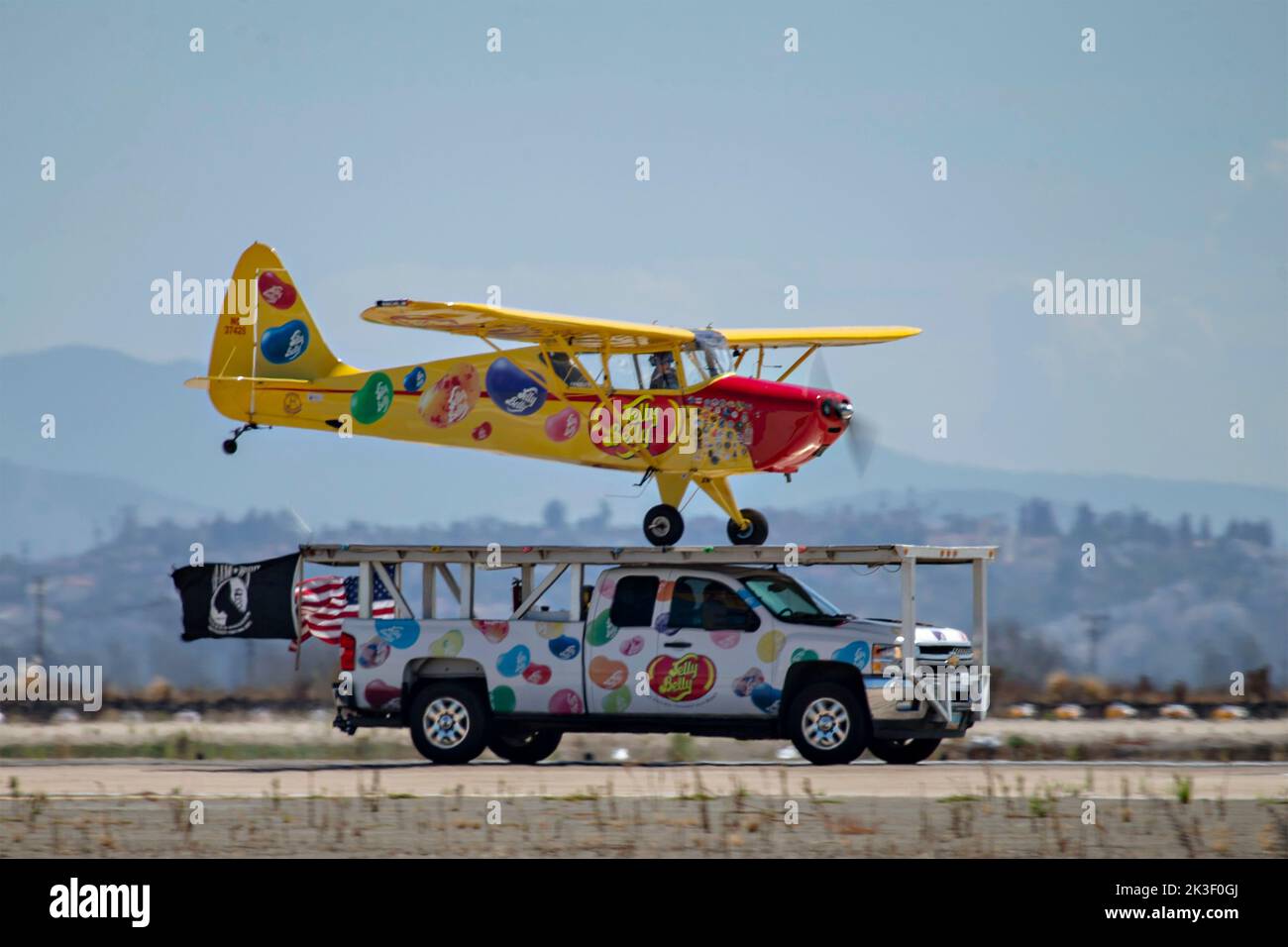 Kent Pietsch, piloting his Interstate Cadet, lands on the roof of a pickup truck as he performs aerobatics during the 2022 Miramar Air Show at MCAS Miramar, September 24, 2022 in San Diego, California. Stock Photo