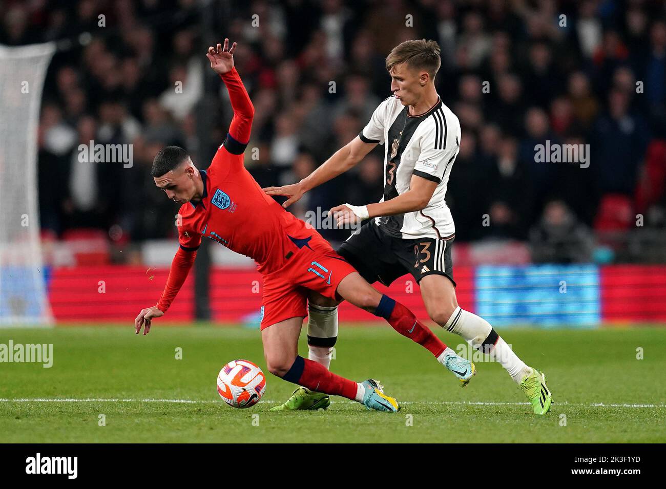 England's Phil Foden and Germany's Nico Schlotterbeck (right) battle for the ball during the UEFA Nations League match at Wembley Stadium, London. Picture date: Monday September 26, 2022. Stock Photo