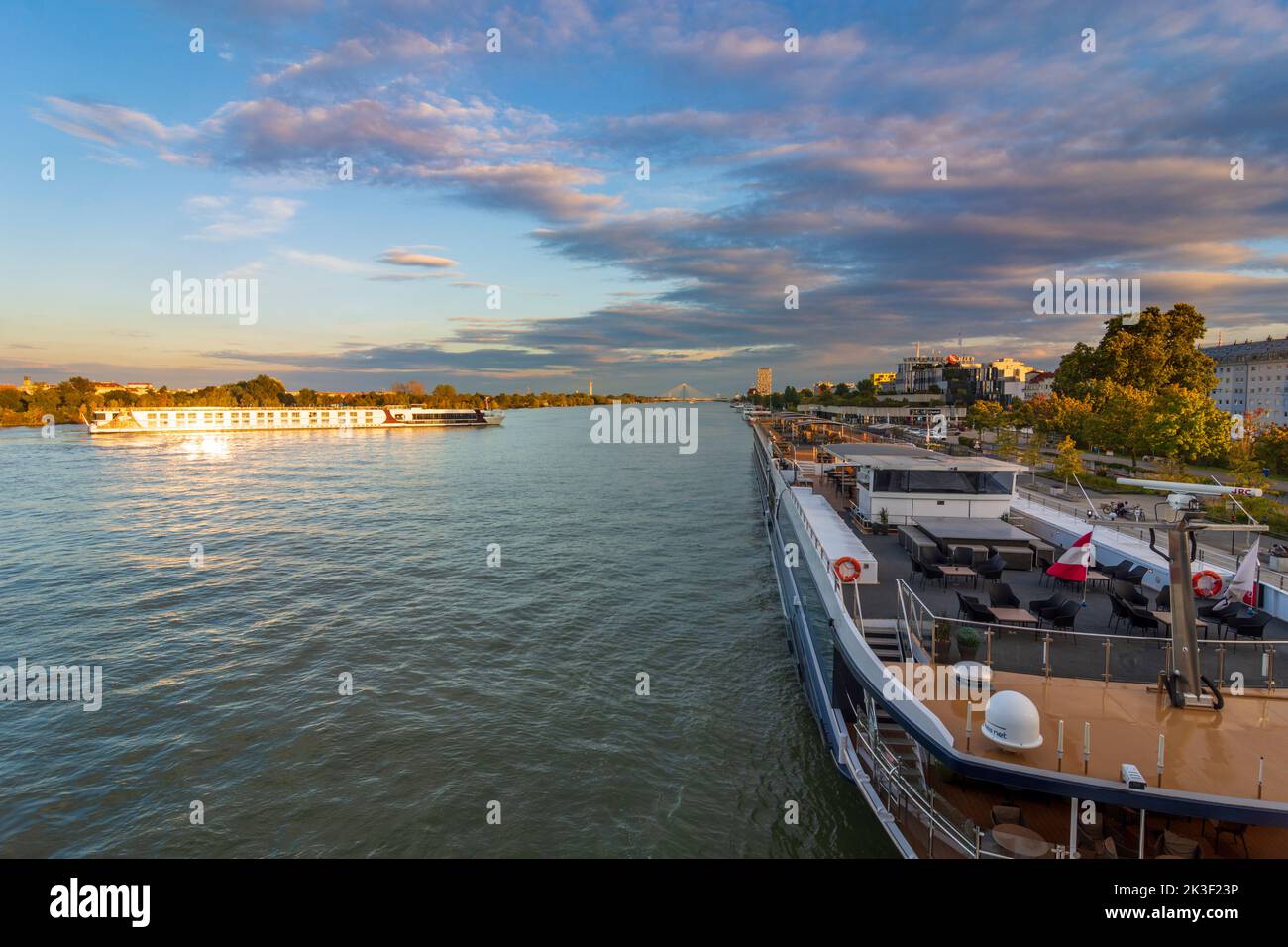 Wien, Vienna: river Donau (Danube), cruise ships, one is turning around, at bridge Reichsbrücke in 02. Leopoldstadt, Wien, Austria Stock Photo