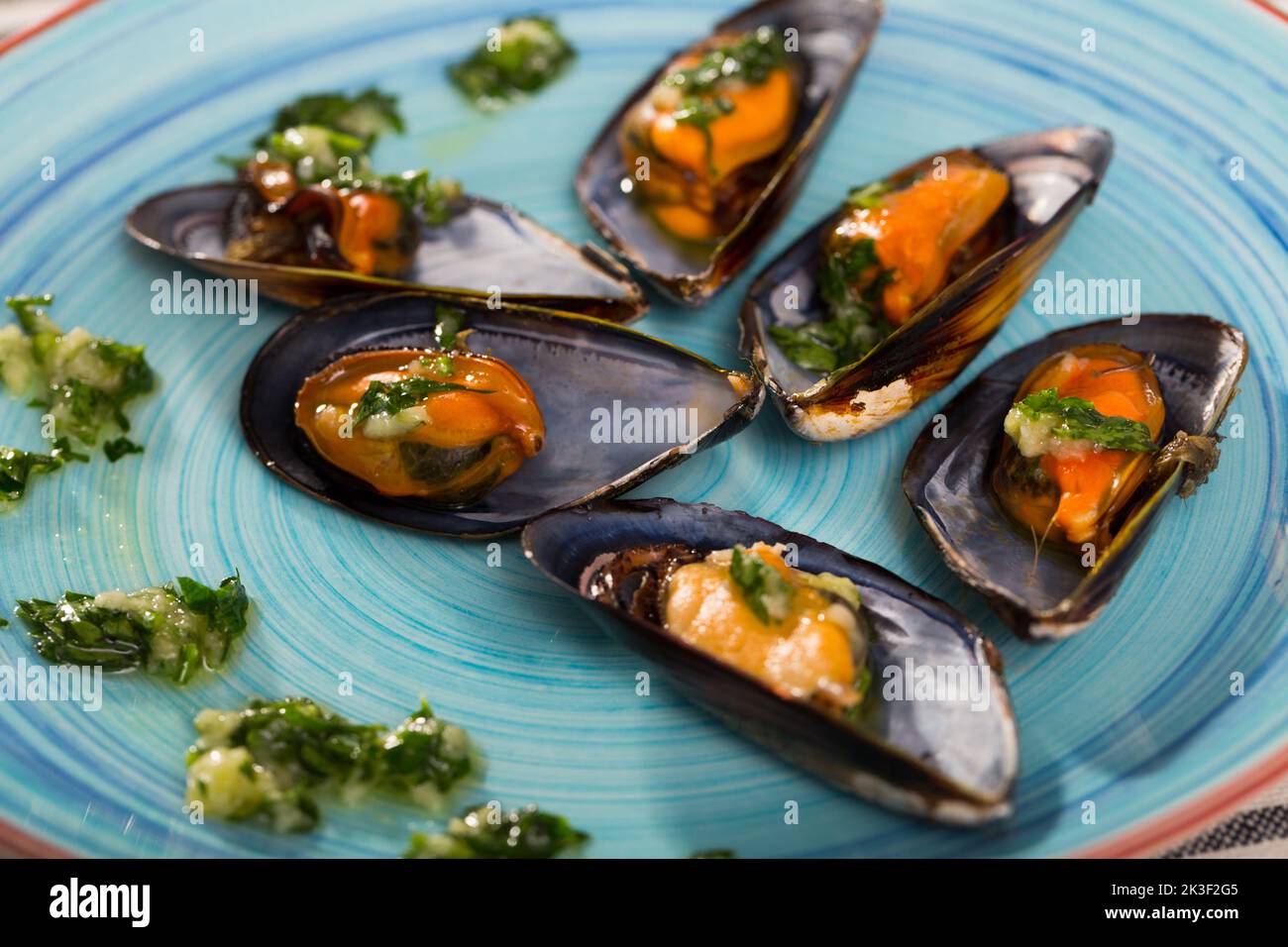 Steamed mussels on blue plate Stock Photo
