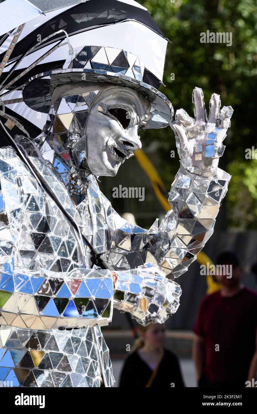 Person dressed up in a shiny mirror suit tipping his hat, at the Beakerhead Festival in Calgary Alberta Canada Stock Photo
