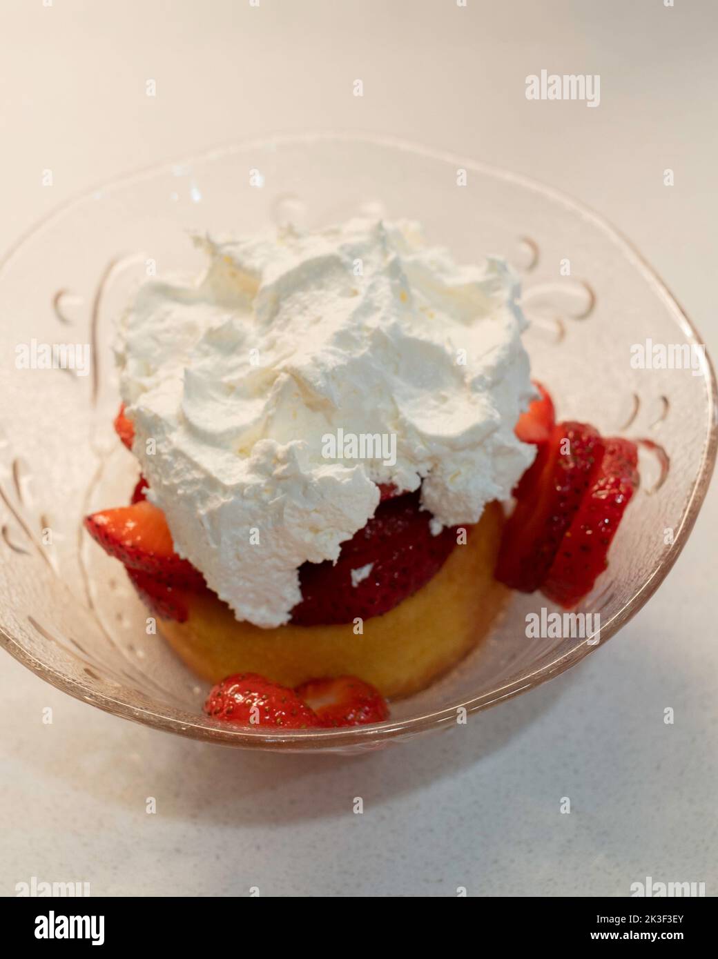 Strawberry shortcake, consisting of fresh sliced strawberries atop a sponge cake with whipped cream on top. An American dessert. USA. Stock Photo