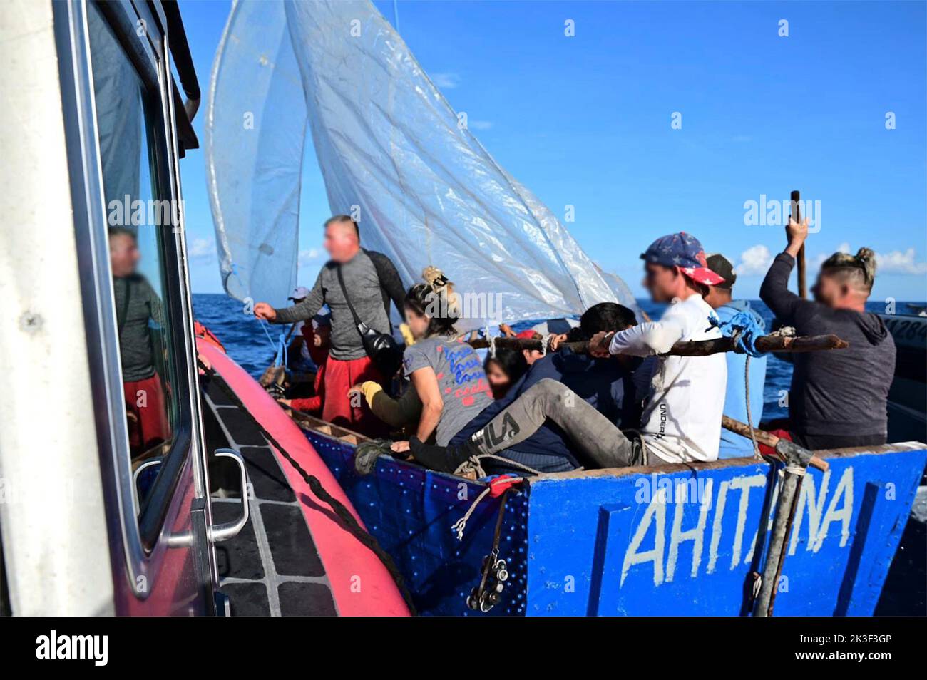 Caribbean Sea, Cayman Islands. 26th Sep, 2022. A Coast Guard law enforcement crew stops a homemade sailboat carrying Cuban migrants attempting to flee the ongoing political instability ahead of Hurricane Ian, September 25, 2022 near the Cayman Islands. Credit: Coast Guard Handout/USCG/Alamy Live News Stock Photo