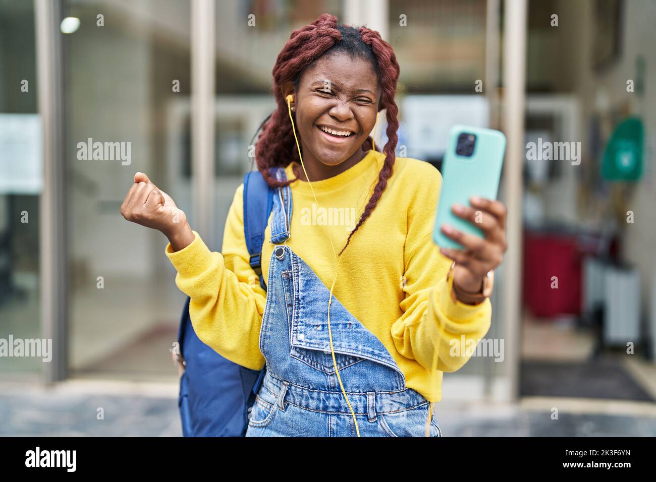 Screaming Call African woman doing video call with smartphone screaming proud ...