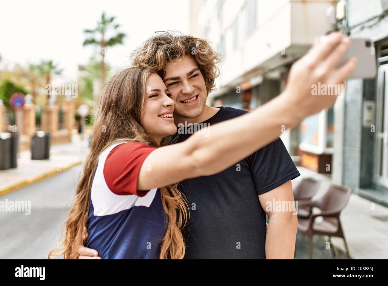 Young caucasian couple smiling happy and hugging make selfie by the ...