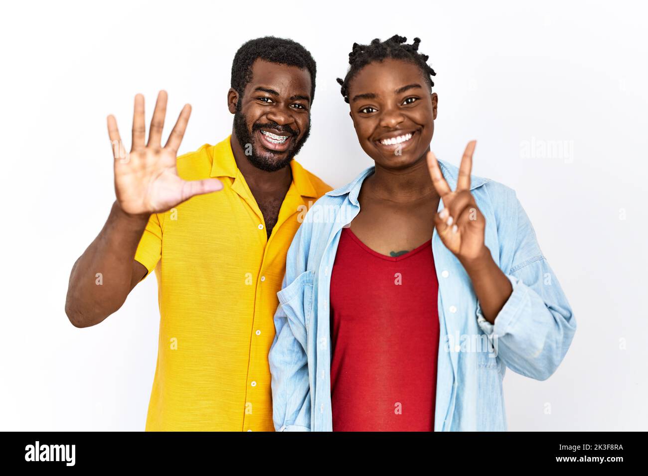 Young african american couple wearing casual clothes showing and ...