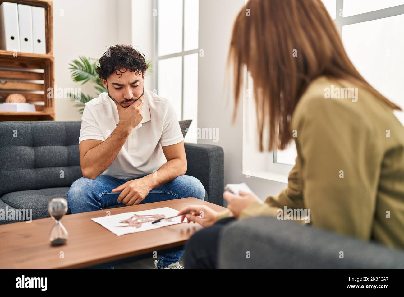 Man and woman having rorscharch test session at psychology center Stock