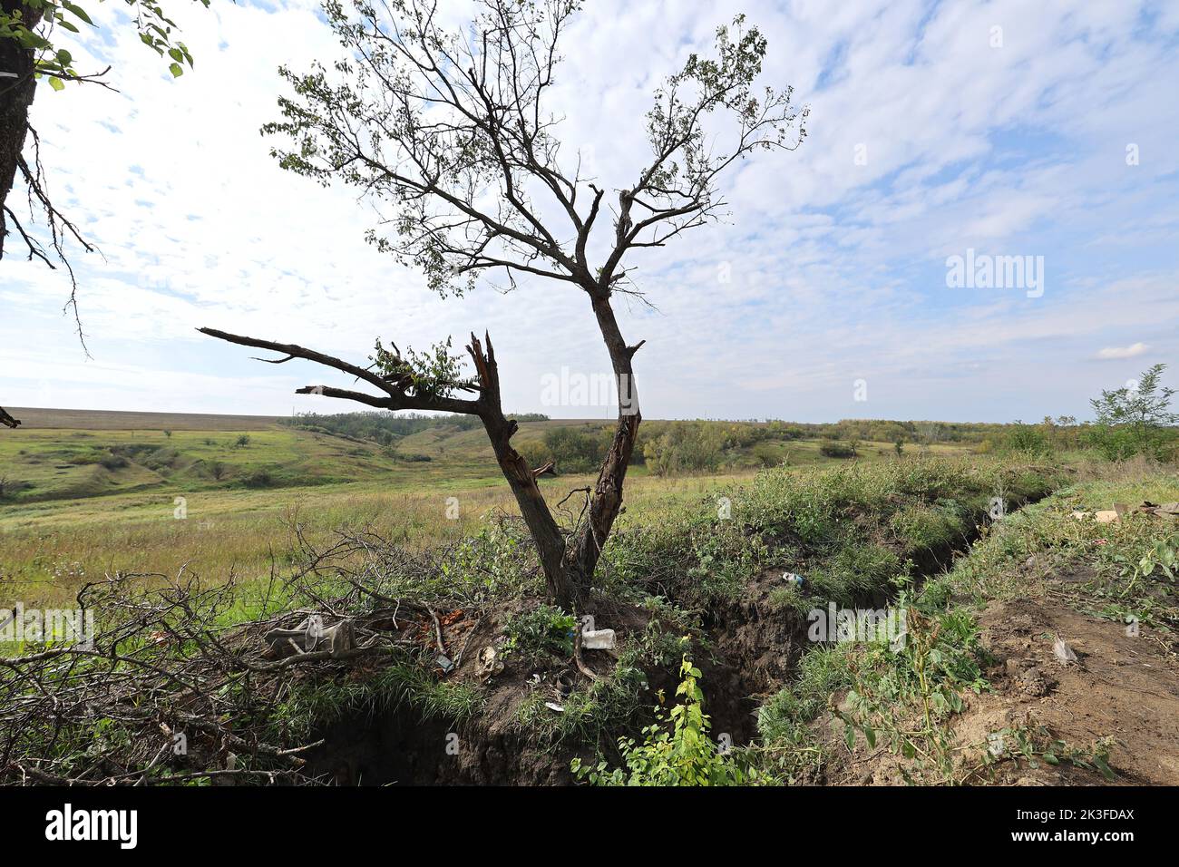 KHARKIV REGION, UKRAINE - SEPTEMBER 26, 2022 - A trench dug in the ground at the former combat positions of Ukrainian servicemen in the village of Dementiyivka recently liberated from russian invaders, Kharkiv Region, north-eastern Ukraine. Stock Photo