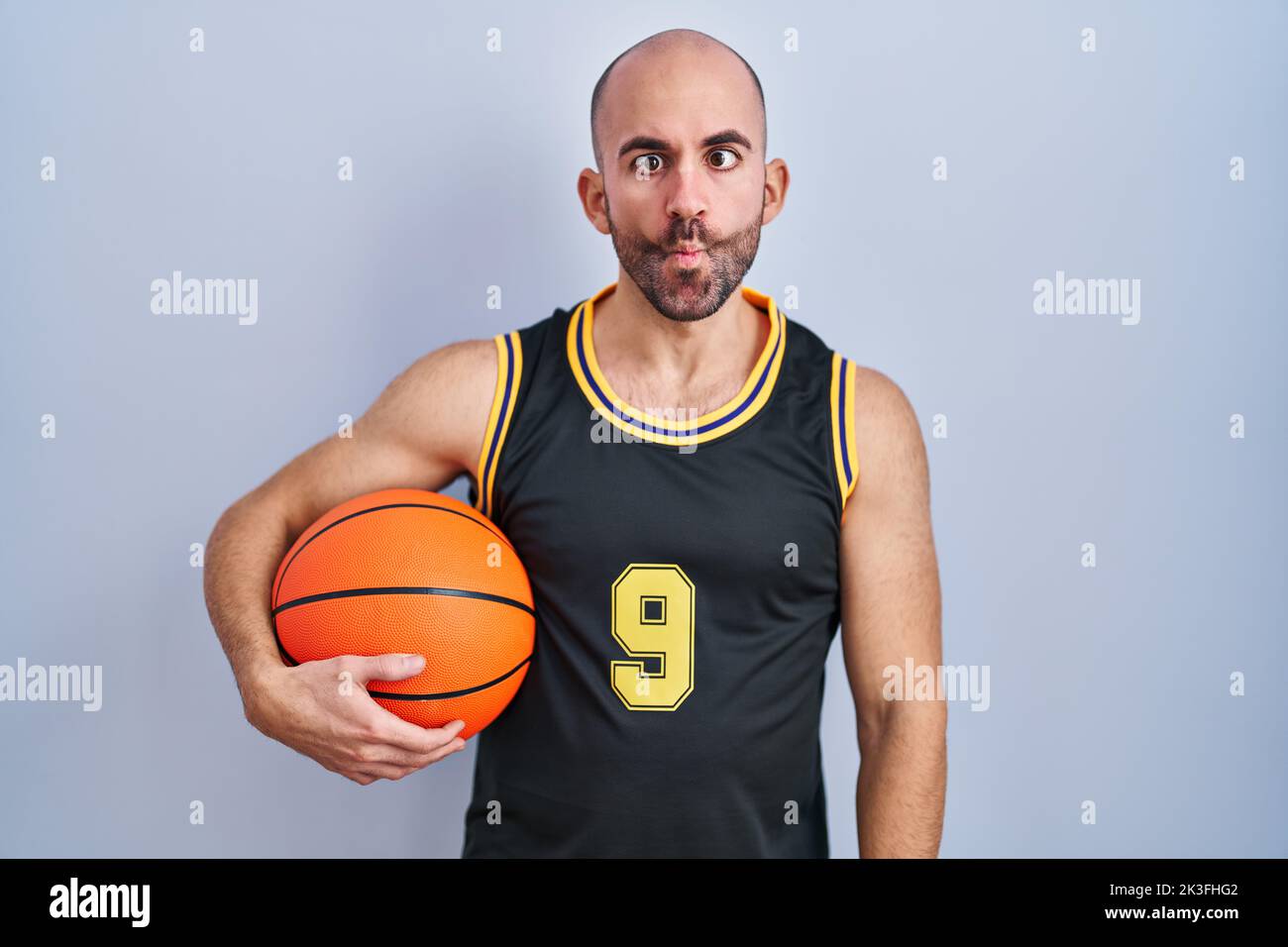 Young hispanic man wearing basketball uniform making fish face with lips,  crazy and comical gesture. funny expression Stock Photo - Alamy
