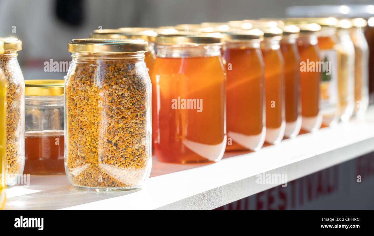 Glass jars with beekeeping products, honey and propolis Stock Photo