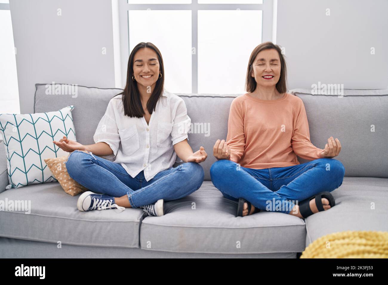 Two women mother and daughter doing yoga exercise at home Stock Photo ...