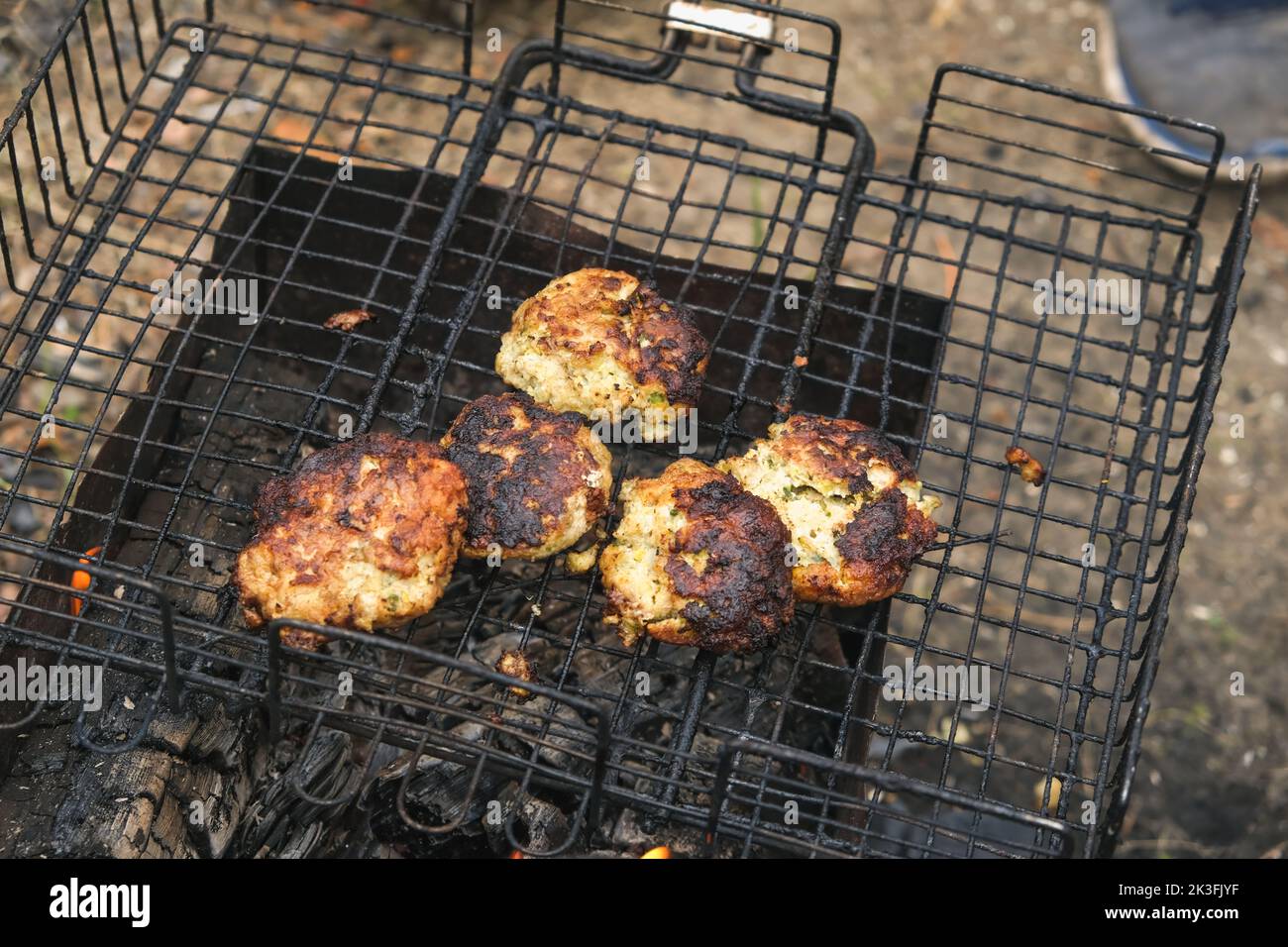 Cooking shish kebab on the grill. Cooking marinated meat on coals. Cooking meat on coals. Stock Photo