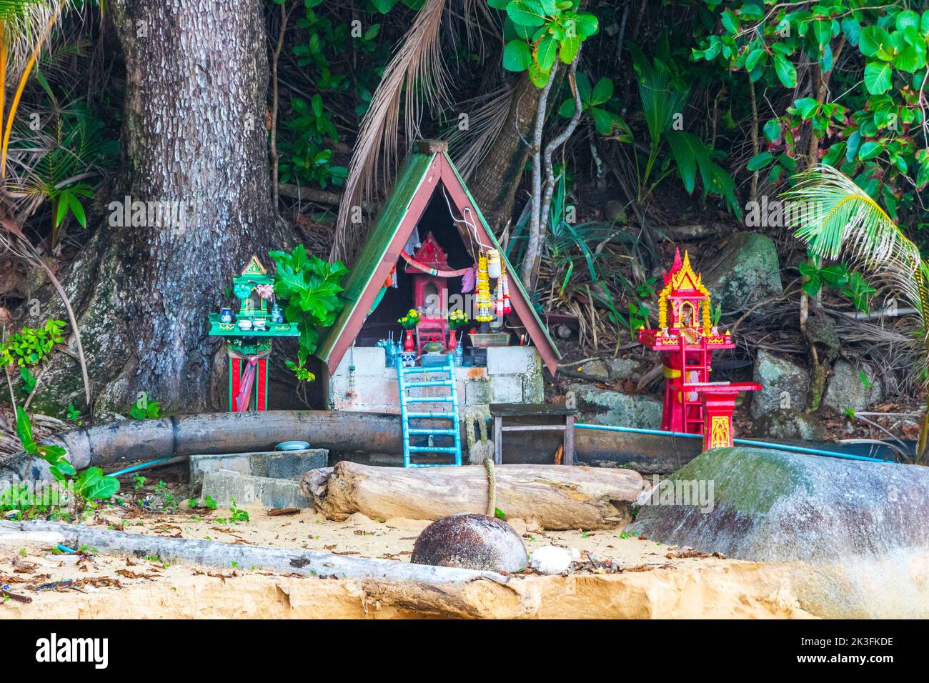 Colorful decorated holy ghost house and holy shrine or small temple in the garden yard street road village in Sakhu Thalang on Phuket island Thailand Stock Photo