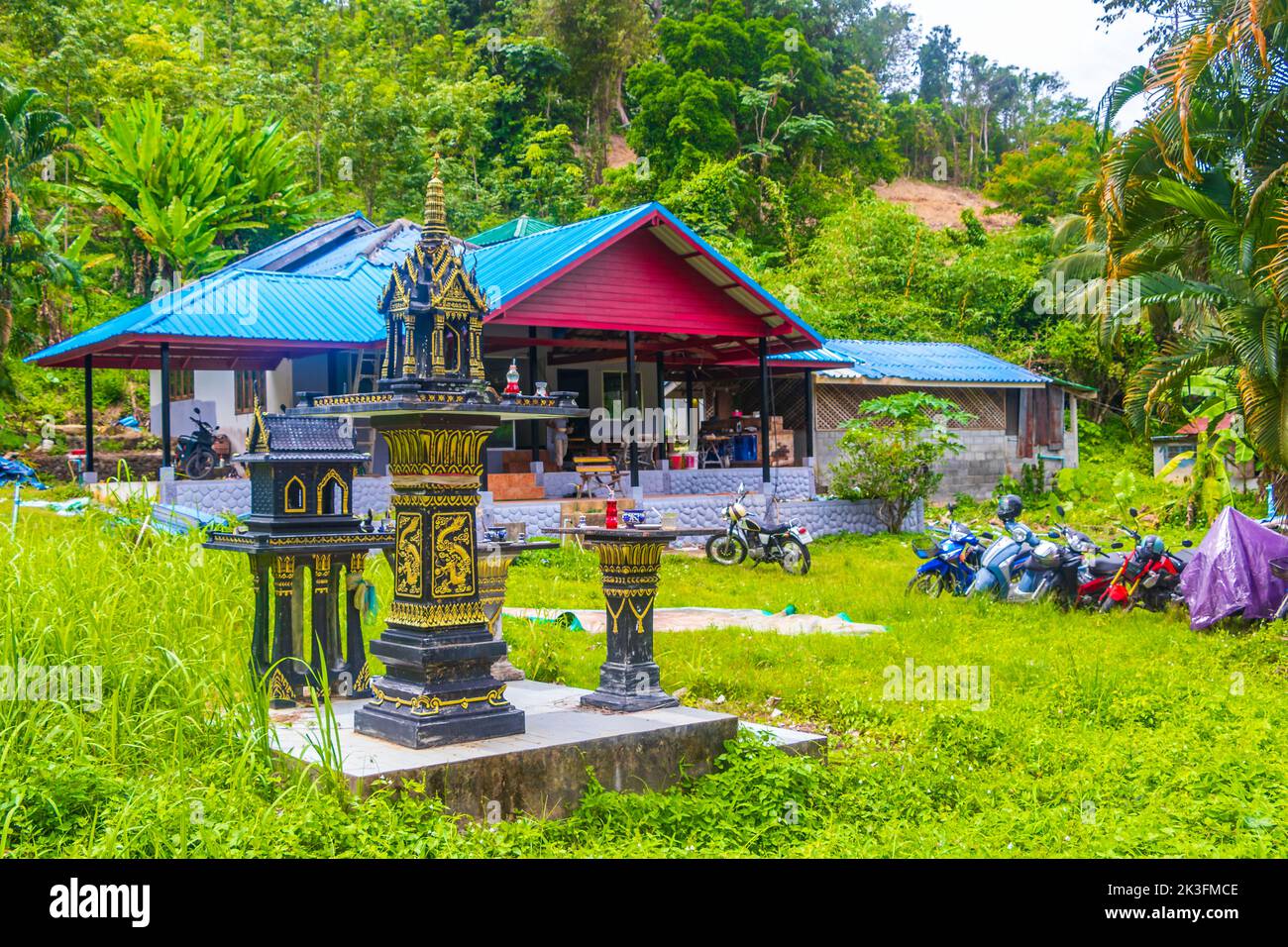 Colorful decorated holy ghost house and holy shrine or small temple in the garden yard street road village in Sakhu Thalang on Phuket island Thailand Stock Photo