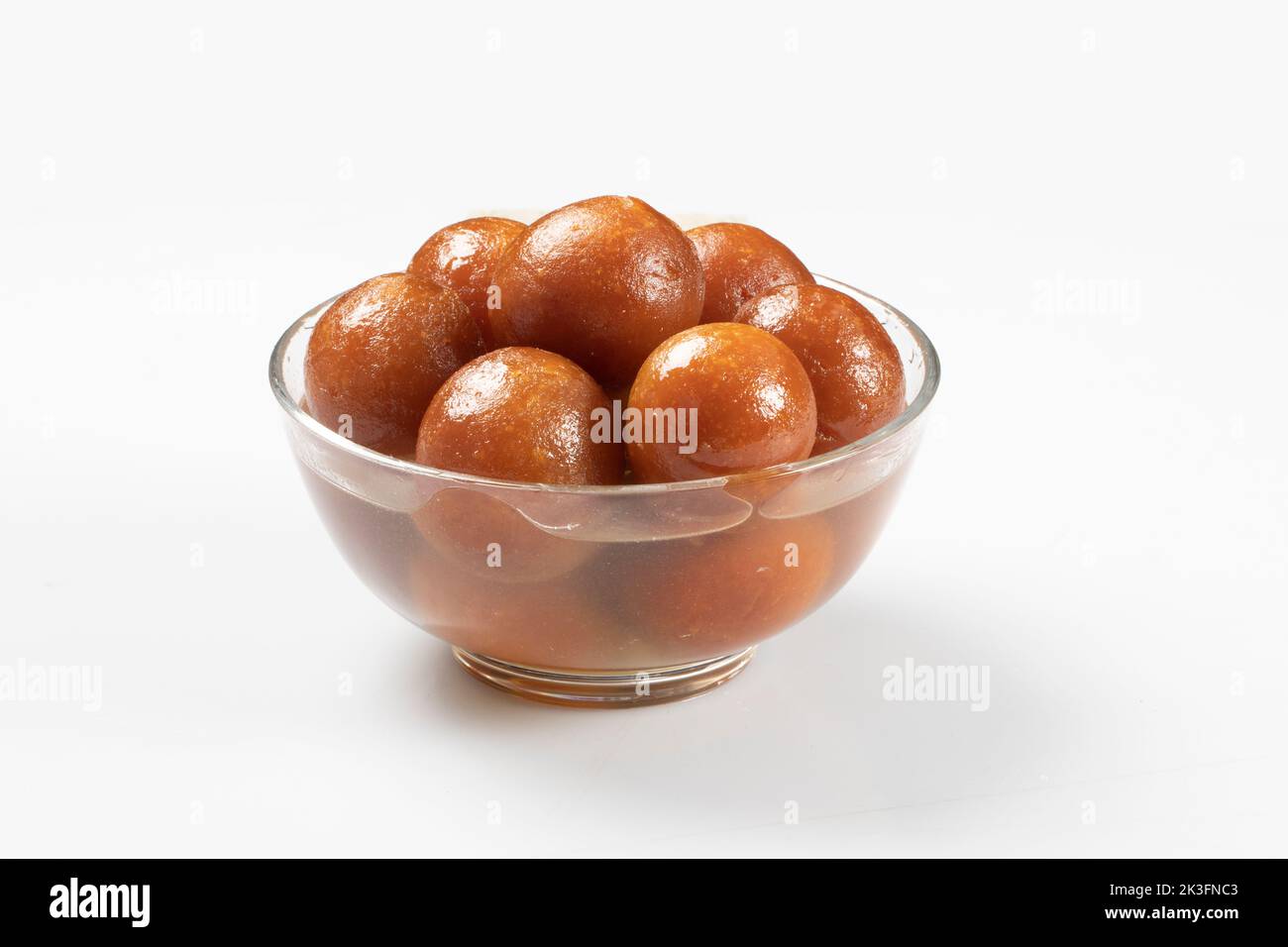 Gulab Jamun with almond and saffron served in white bowl. Indian sweet Gulab jamun closeup view. Isolated In White Background Stock Photo