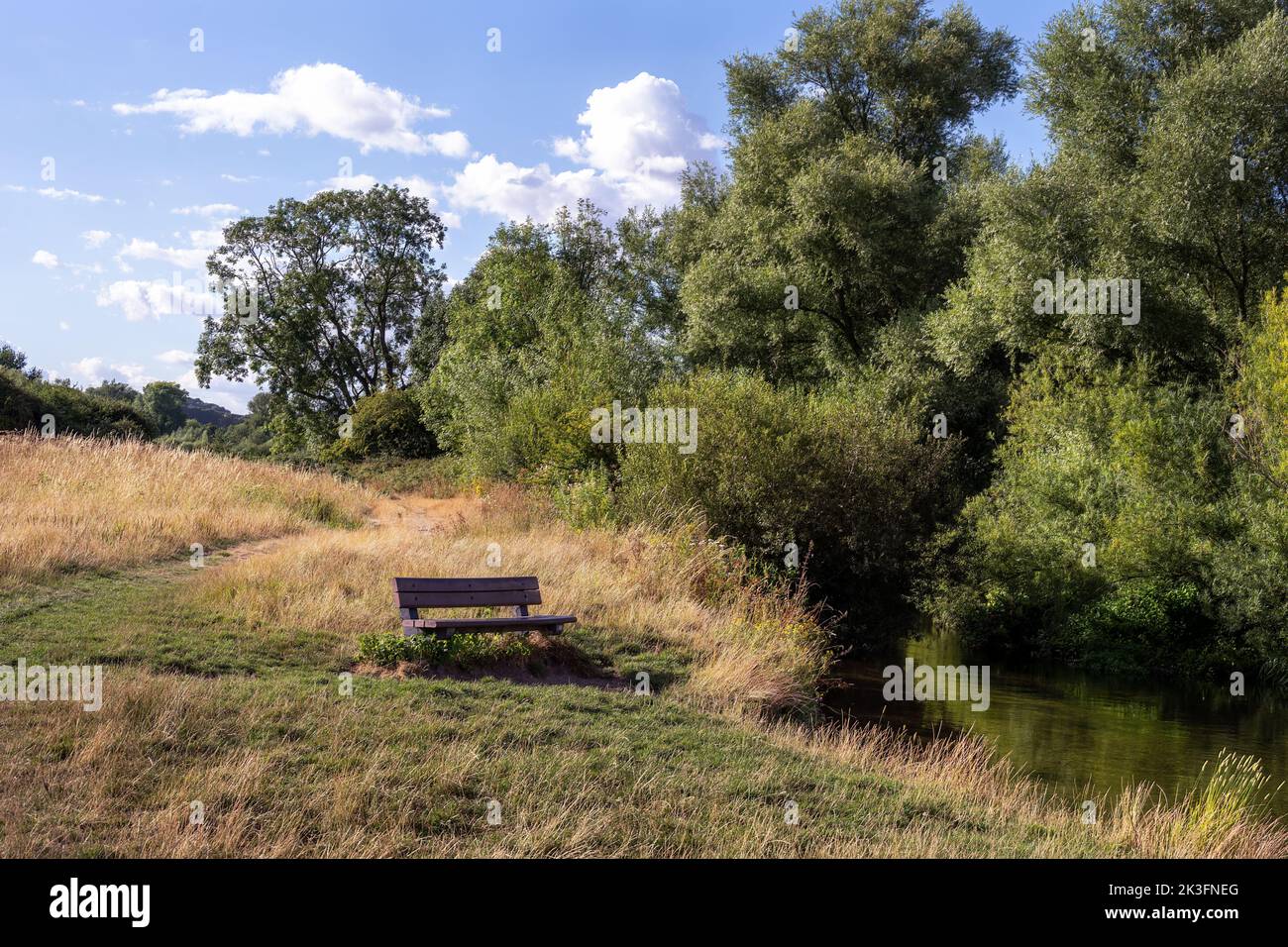 Walking on a path along the river Avon on a sunny summer afternoon, near Salisbury, Wiltshire, England Stock Photo