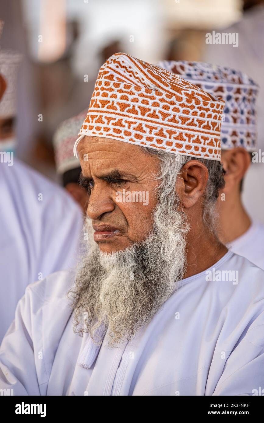 Portrait of a bearded man with kuma (omani traditional round hat) at friday morning cattle market, Nizwa, Oman Stock Photo